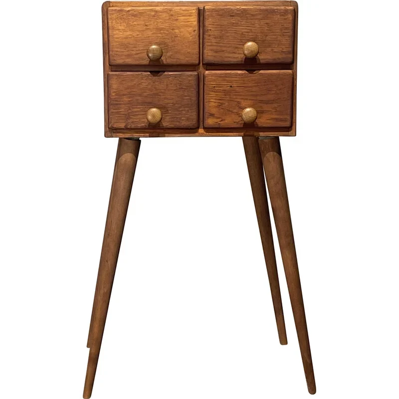 A vintage wooden cabinet on tall tapered legs
