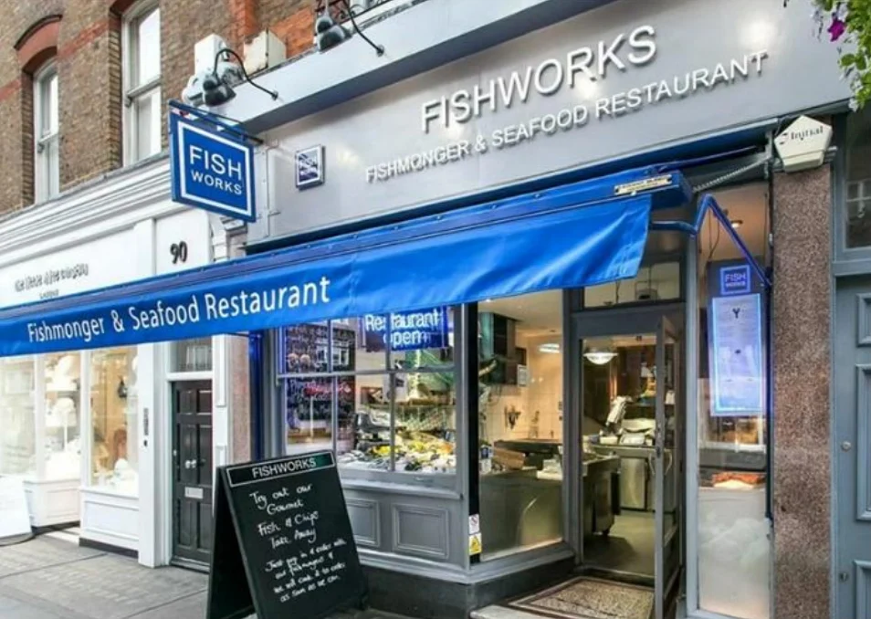 The blue shopfront of a fishmonger and seafood restaurant in London