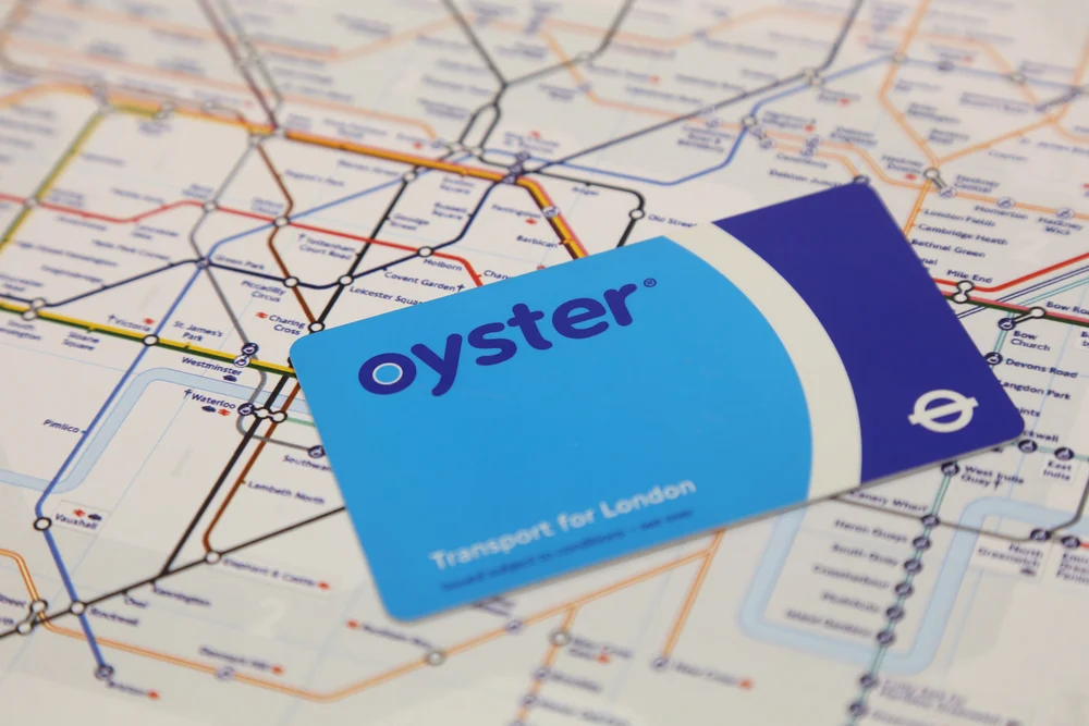 A blue Oyster card lying on a London Underground map
