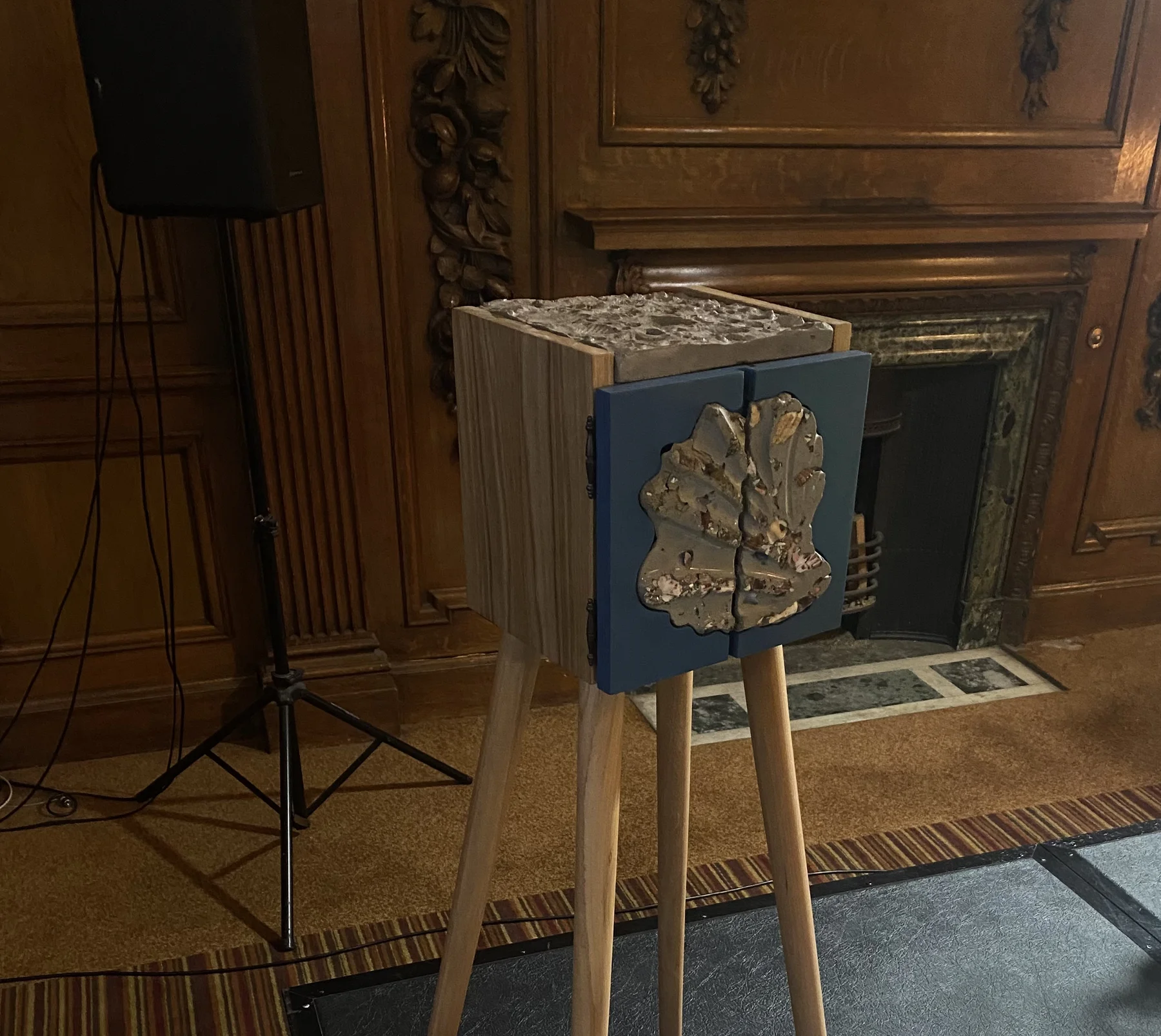 The cabinet in a wood-panelled room beside a marble fireplace