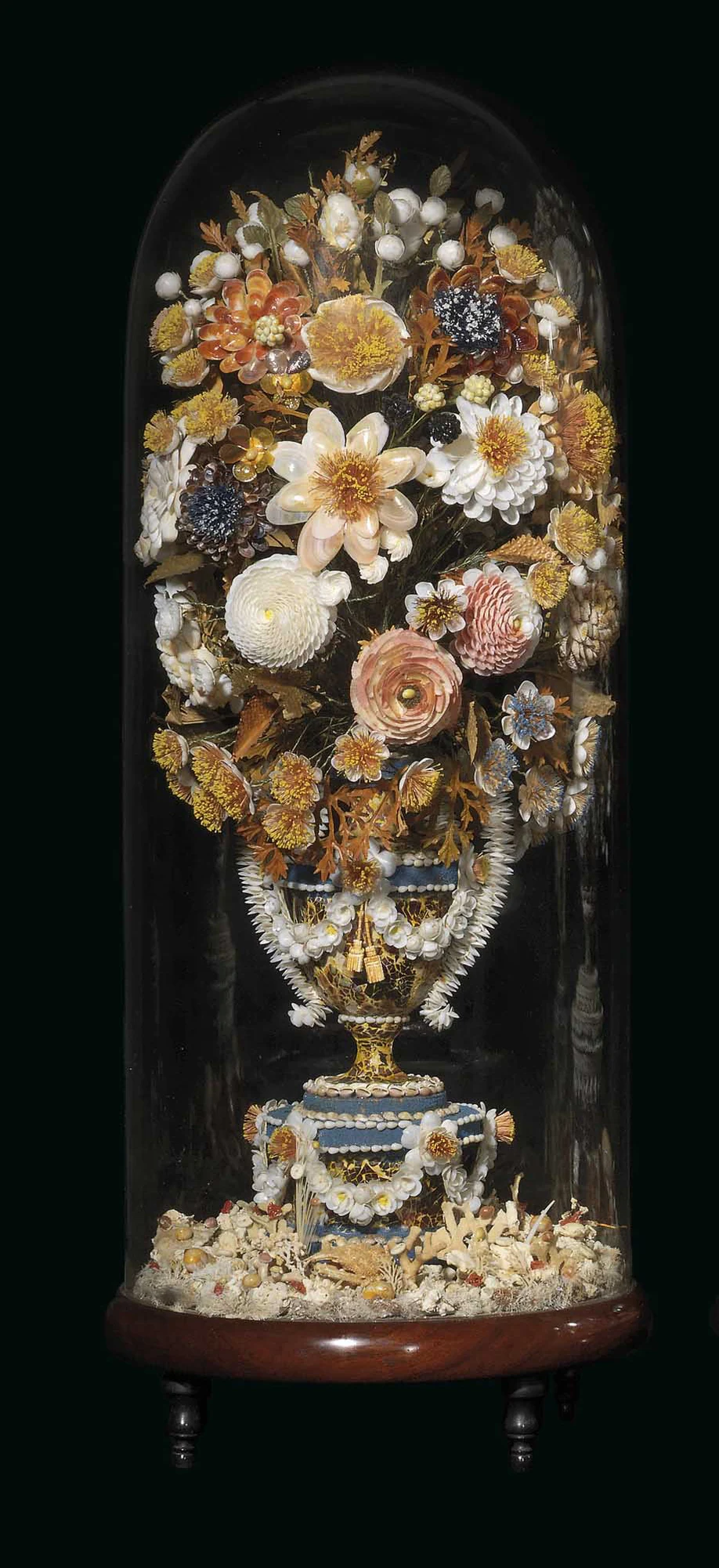 A 19th-century floral ornament made of shells under a glass dome