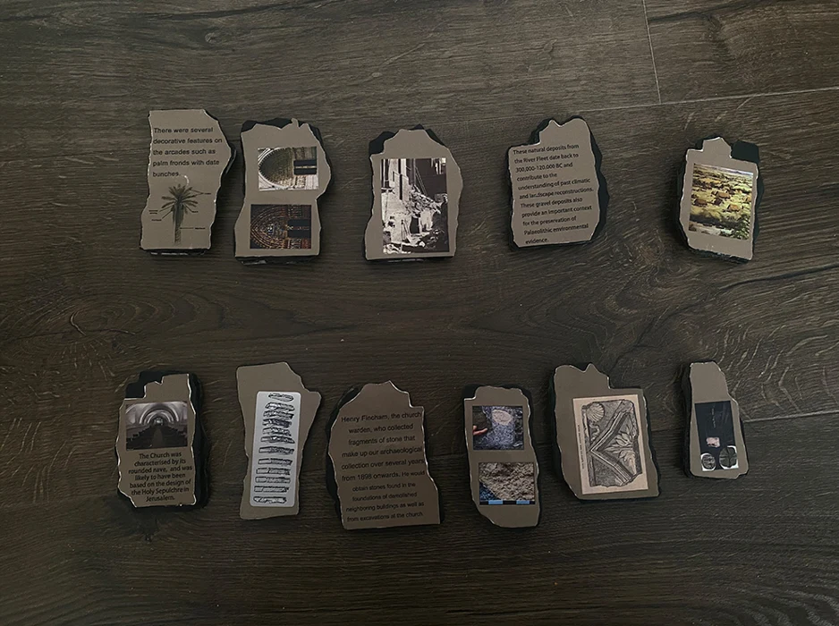 Twelve foam board slices laid out, each face printed with a short text or picture