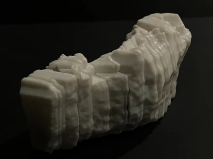 The assembled white resin print on a black background
